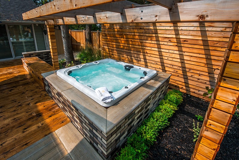 beautiful hot tub with landscaping
