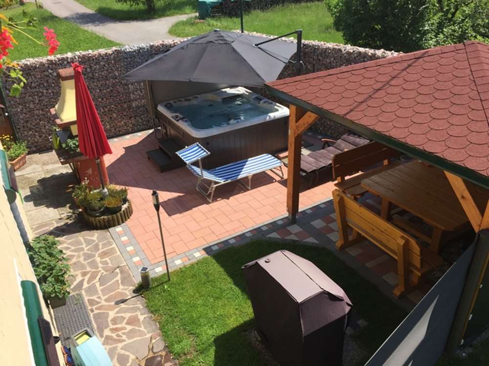 hot tub covered with patio umbrella