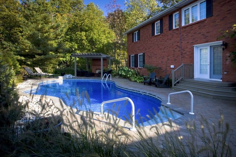 inground pool woth inground stairs and above ground railing