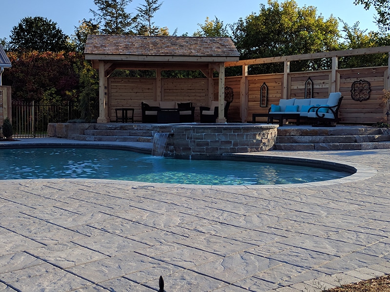 waterfall and steps on an inground pool feature